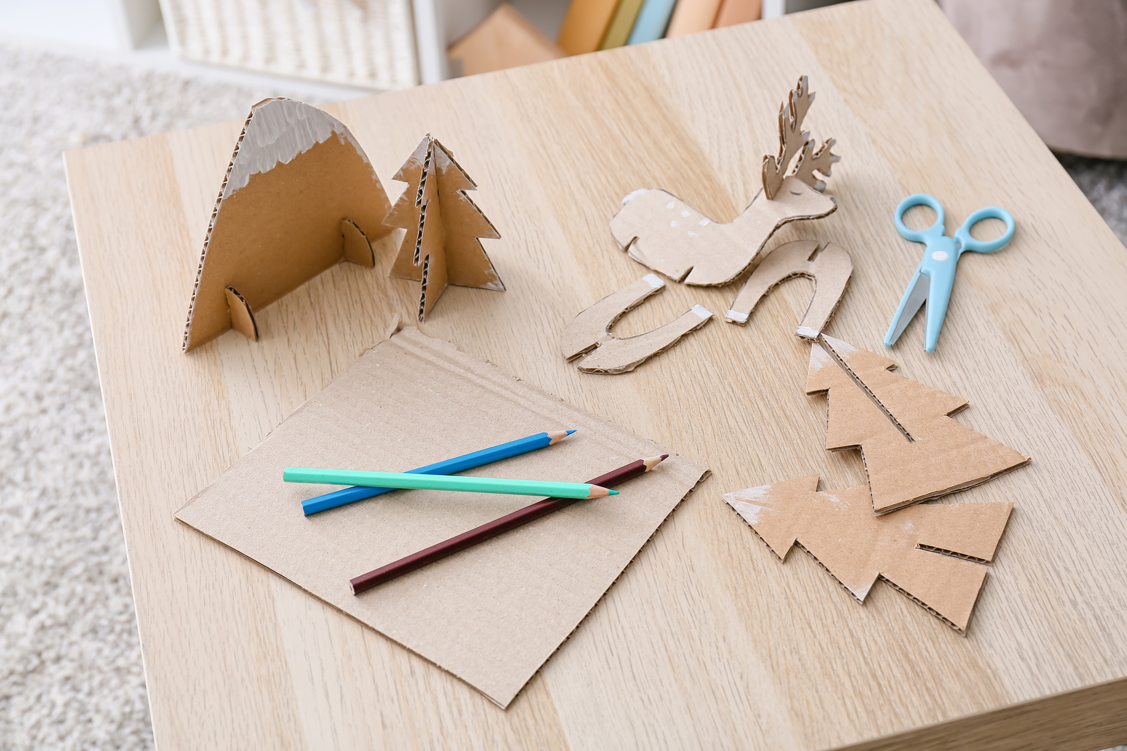 Handmade Cardboard Toys and Stationery Supplies on Wooden Table
